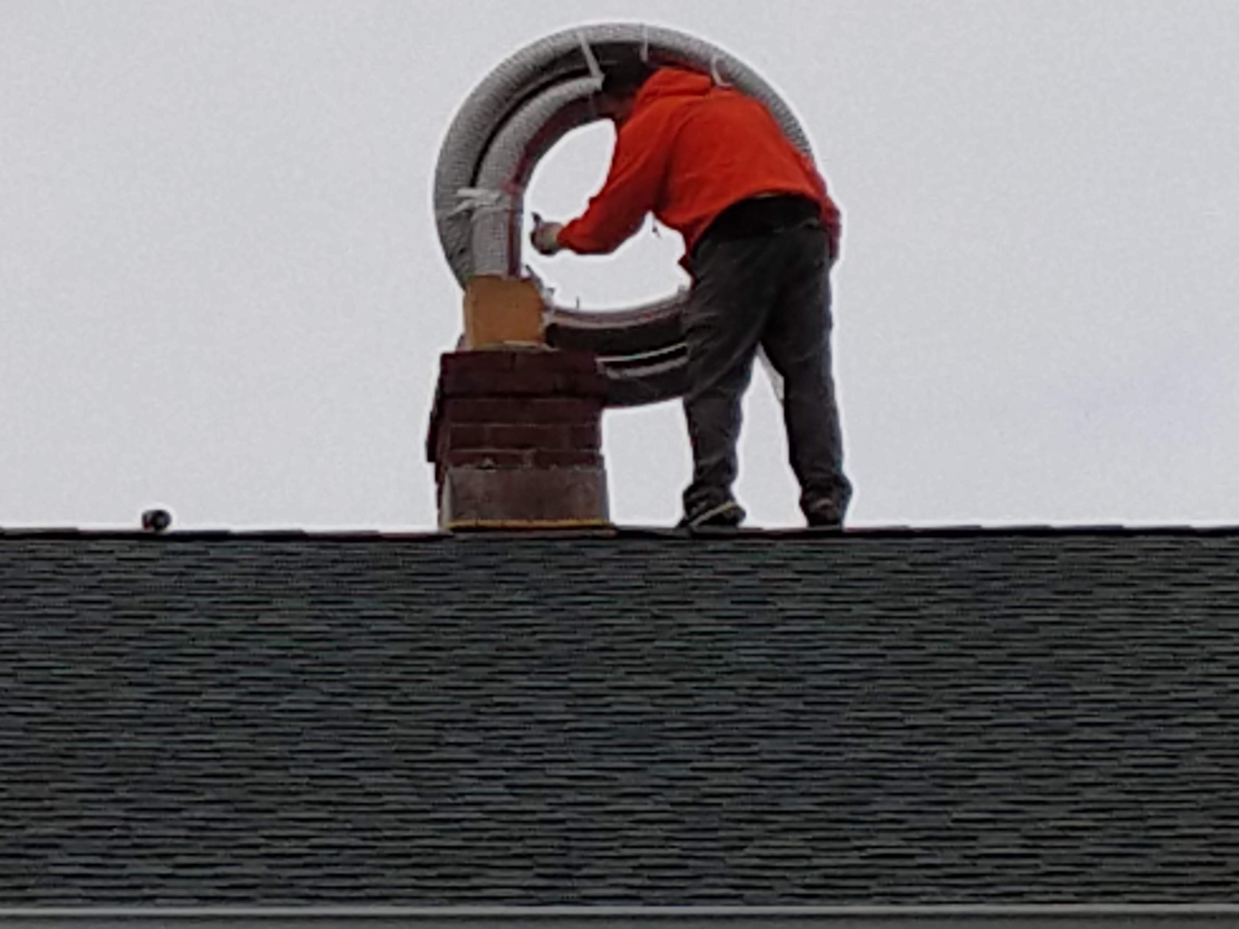 Flexible stainless chimney liner being installed in Franklin Square, New York